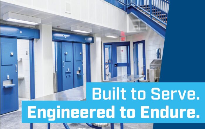 Interior of a detention facility with secure blue doors and stairways, featuring the message “Built to Serve. Engineered to Endure.”